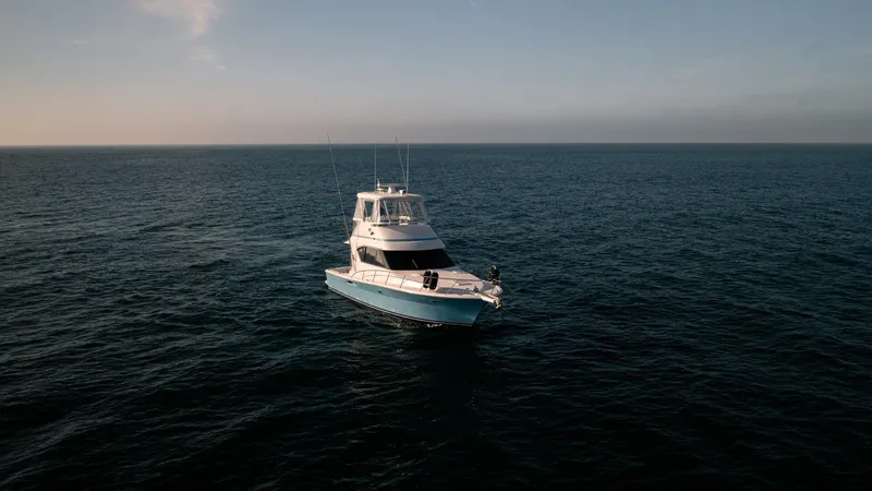 Skiesta Yacht Photos Pics 2002 Riviera 40 Flybridge yacht cruising on open sea.