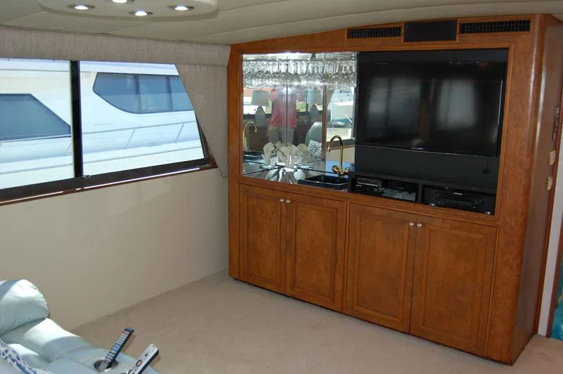  Yacht Photos Pics Interior of 1990 Hatteras 78 Aft Cockpit Motoryacht with entertainment center and large window.