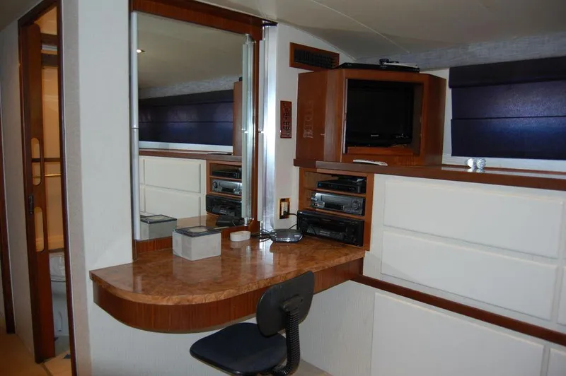  Yacht Photos Pics 1990 Hatteras 78 Aft Cockpit Motoryacht interior with desk, mirror, and entertainment center.
