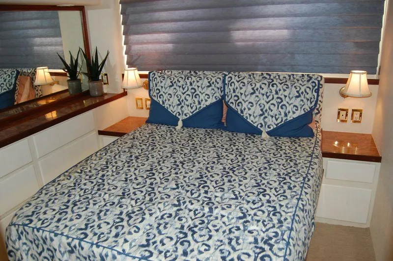  Yacht Photos Pics Luxurious bedroom in 1990 Hatteras 78 Aft Cockpit Motoryacht with elegant bedding.