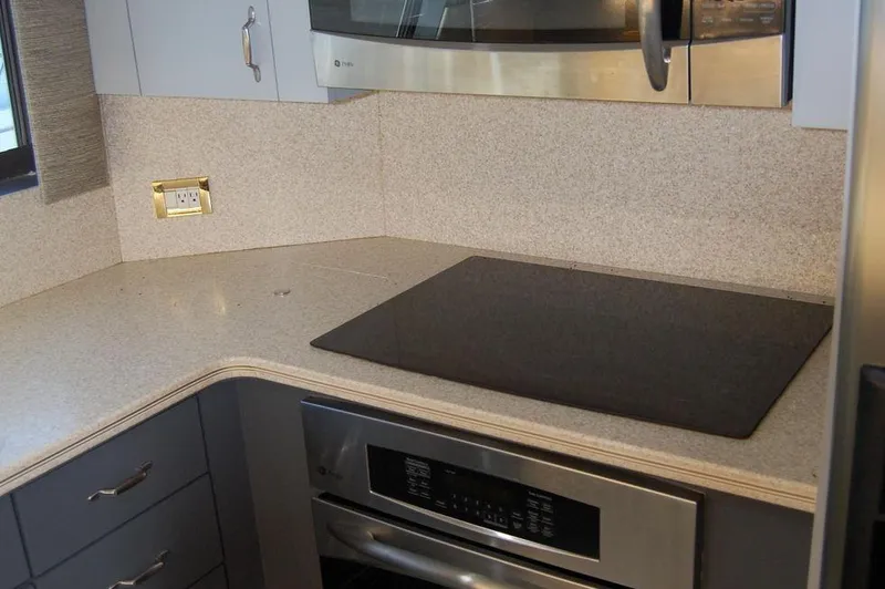  Yacht Photos Pics Modern kitchen in 1990 Hatteras 78 Aft Cockpit Motoryacht with stovetop and microwave.