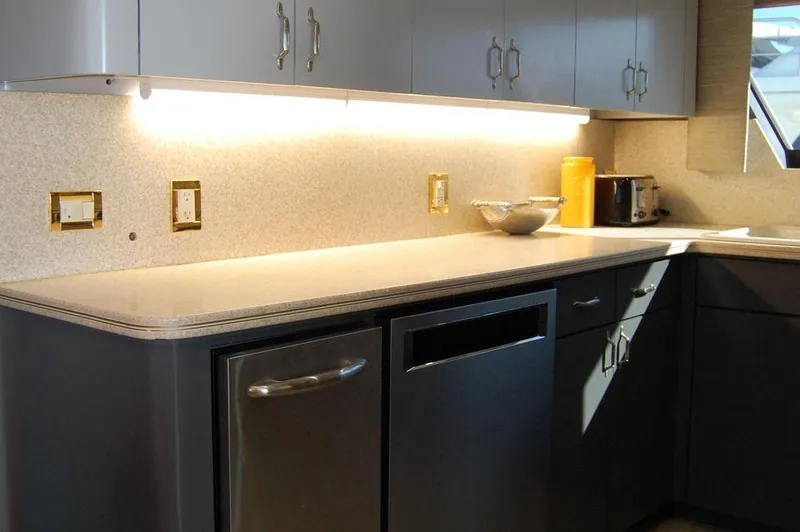  Yacht Photos Pics Modern kitchen in 1990 Hatteras 78 Aft Cockpit Motoryacht with sleek countertops.