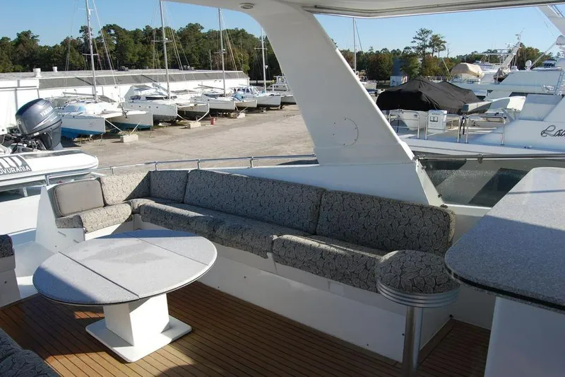  Yacht Photos Pics Spacious deck seating on a 1990 Hatteras 78 Aft Cockpit Motoryacht in a marina.