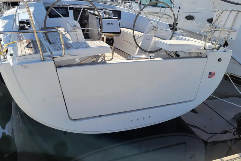  Yacht Photos Pics 2024 Hanse 388 yacht stern view with dual steering wheels and American flag.