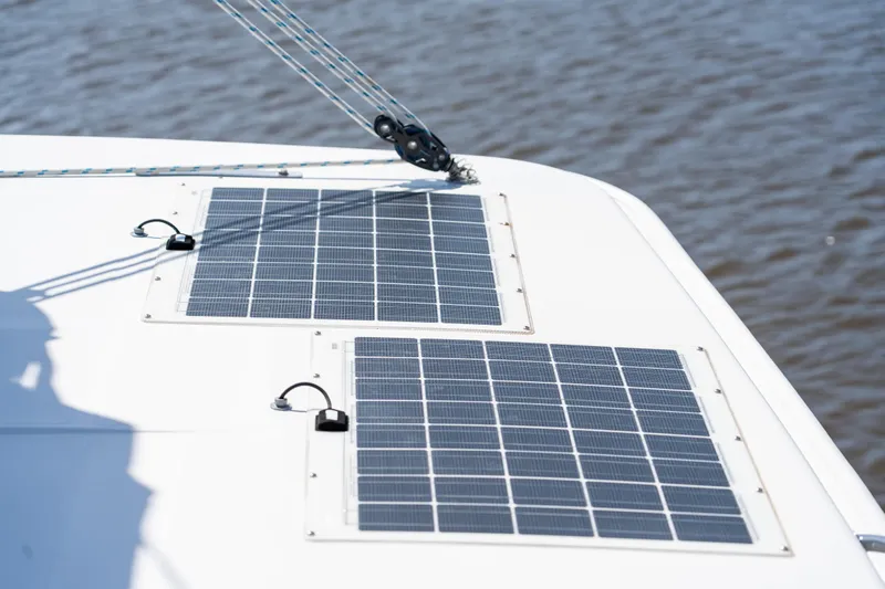 Playtime Yacht Photos Pics Solar panels on 2016 Leopard 44 Owners Version catamaran deck, near water.
