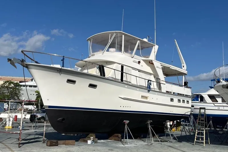 Bedouin Yacht Photos Pics 1998 DeFever 44 Sundeck Trawler on dry dock under clear blue sky.