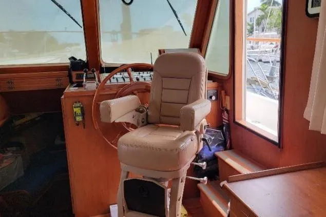 Bedouin Yacht Photos Pics 1998 DeFever 44 Sundeck Trawler helm with captain's chair and wooden interior.