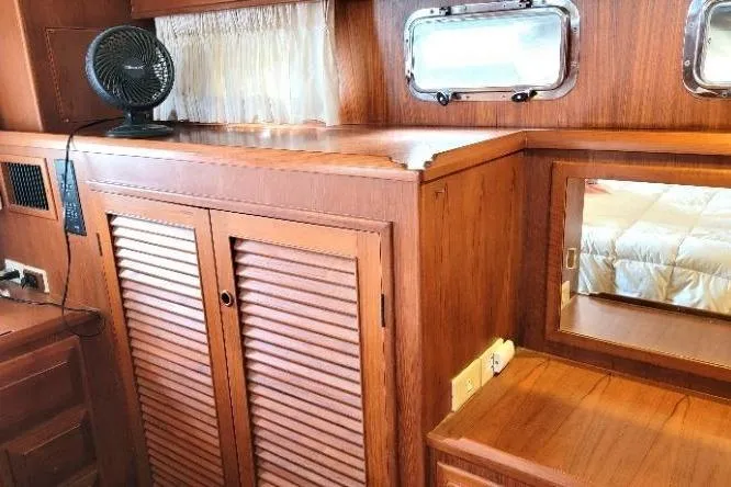 Bedouin Yacht Photos Pics 1998 DeFever 44 Sundeck Trawler interior with wooden cabinetry and porthole windows.