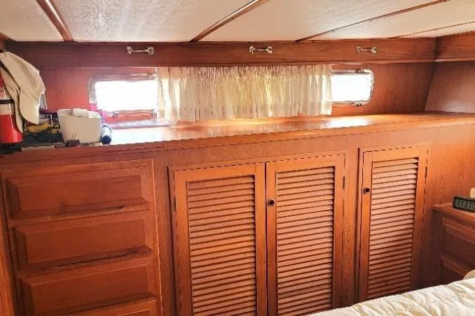 Bedouin Yacht Photos Pics Interior of 1998 DeFever 44 Sundeck Trawler with wooden cabinets and small windows.