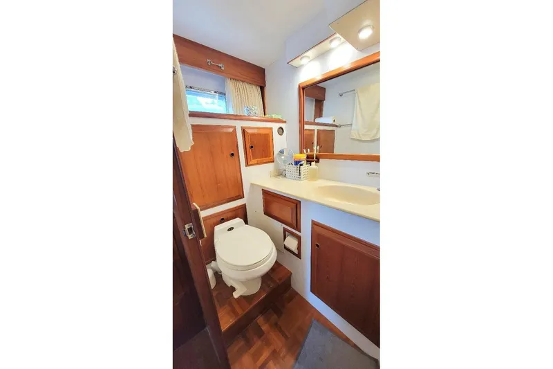 Bedouin Yacht Photos Pics Bathroom interior of 1998 DeFever 44 Sundeck Trawler with wooden cabinetry and modern fixtures.
