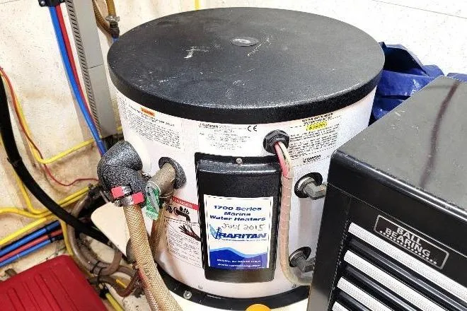 Bedouin Yacht Photos Pics Water heater in 1998 DeFever 44 Sundeck Trawler engine room, featuring Hatteras 1700 Series.