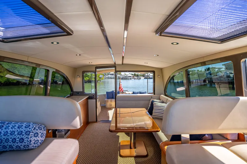 Miller Time Yacht Photos Pics Luxurious interior of 2017 Palm Beach Motor Yachts PB45 with panoramic windows and elegant seating.