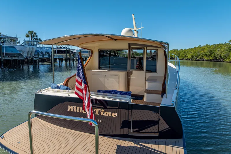 Miller Time Yacht Photos Pics 2017 Palm Beach Motor Yachts PB45 docked, featuring elegant design and American flag.