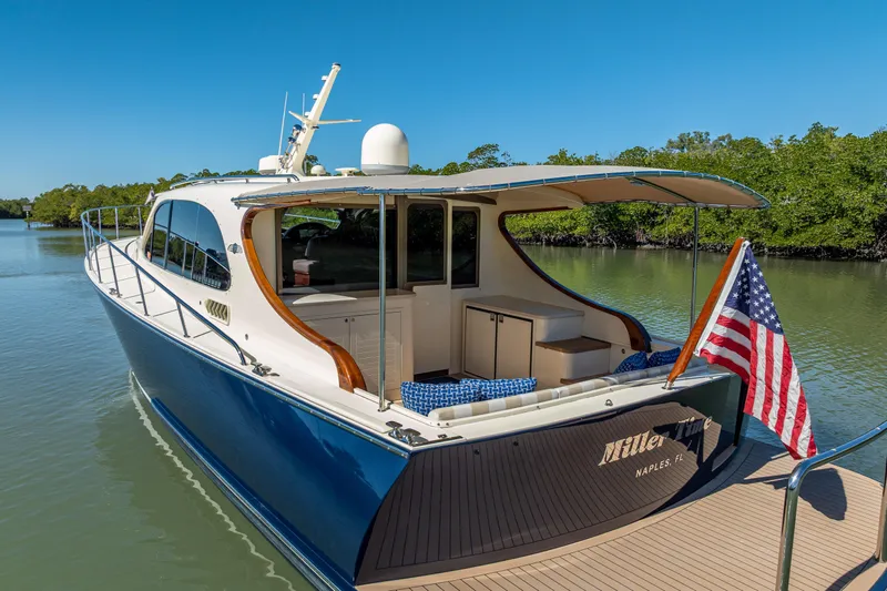 Miller Time Yacht Photos Pics 2017 Palm Beach Motor Yachts PB45 docked, featuring sleek design and American flag.