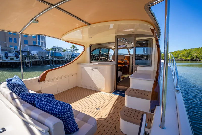 Miller Time Yacht Photos Pics 2017 Palm Beach Motor Yachts PB45 interior with elegant seating and scenic marina view.