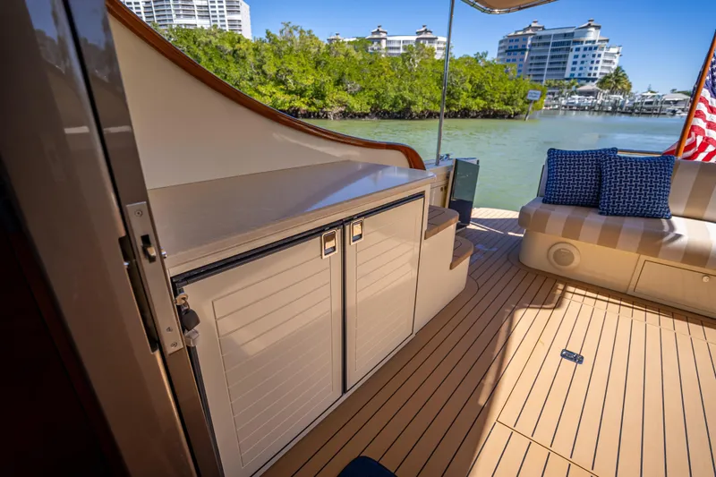 Miller Time Yacht Photos Pics Luxurious 2017 Palm Beach Motor Yachts PB45 deck with seating and scenic waterfront view.