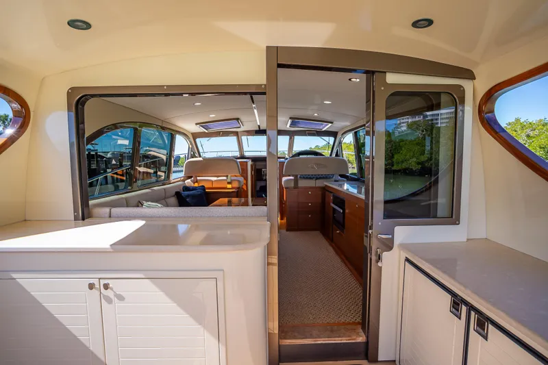 Miller Time Yacht Photos Pics Luxurious interior of 2017 Palm Beach Motor Yachts PB45, featuring elegant seating and cabinetry.