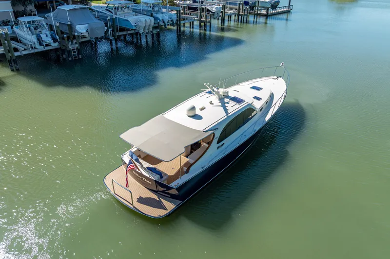 Miller Time Yacht Photos Pics 2017 Palm Beach Motor Yachts PB45 cruising in a serene marina setting.