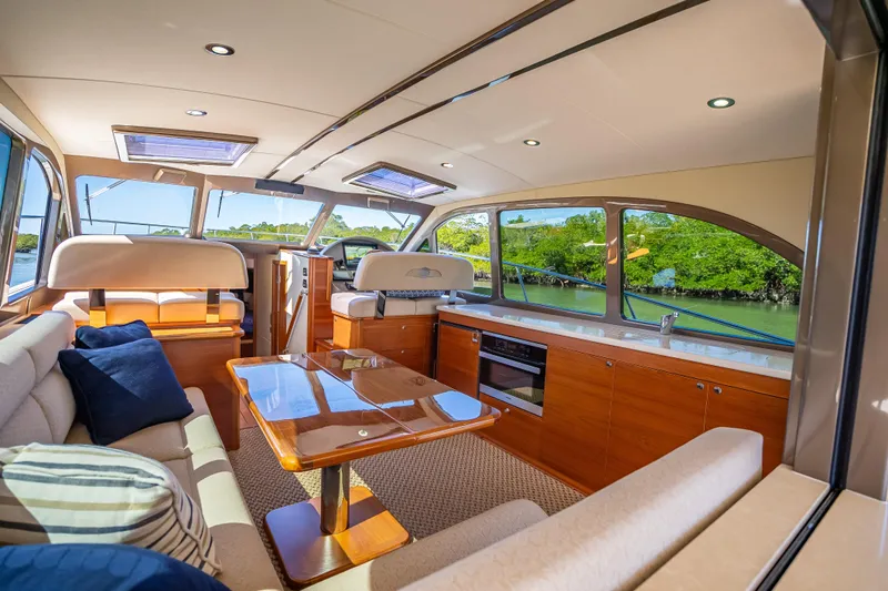 Miller Time Yacht Photos Pics Luxurious interior of 2017 Palm Beach Motor Yachts PB45 with elegant seating and panoramic windows.