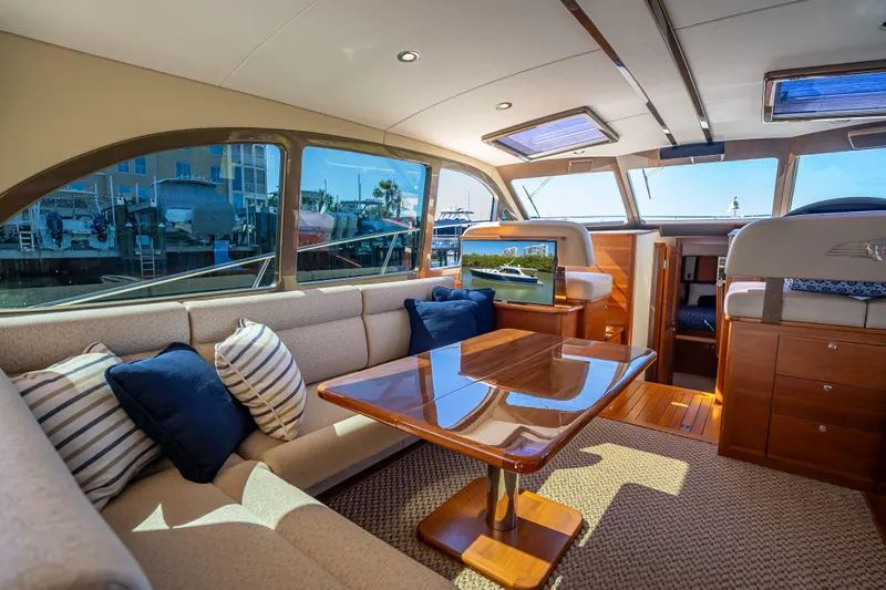 Miller Time Yacht Photos Pics Luxurious interior of 2017 Palm Beach Motor Yachts PB45 with elegant seating and wooden table.