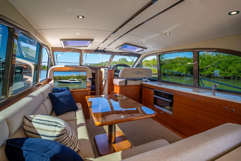 Miller Time Yacht Photos Pics Luxurious interior of 2017 Palm Beach Motor Yachts PB45 with elegant seating and panoramic windows.