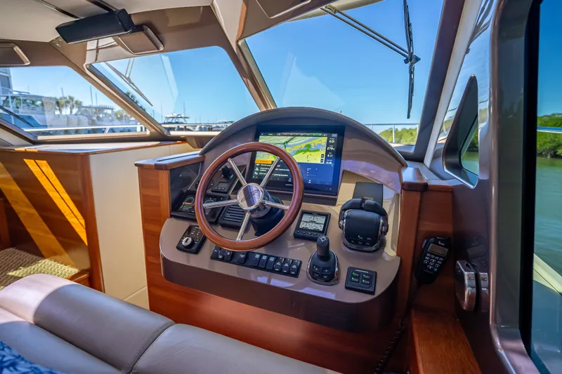 Miller Time Yacht Photos Pics 2017 Palm Beach Motor Yachts PB45 helm with modern navigation controls and wooden accents.