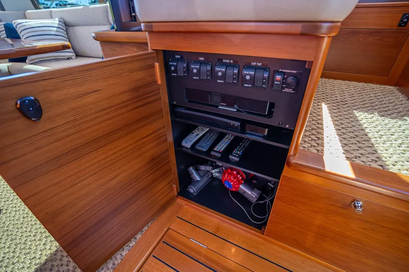 Miller Time Yacht Photos Pics 2017 Palm Beach Motor Yachts PB45 interior cabinet with control panel and storage.