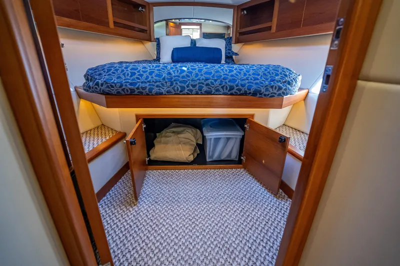 Miller Time Yacht Photos Pics Luxurious 2017 Palm Beach Motor Yachts PB45 cabin interior with storage and cozy bedding.