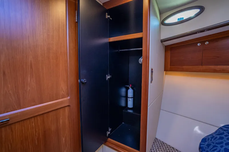 Miller Time Yacht Photos Pics Interior of 2017 Palm Beach Motor Yachts PB45, featuring a wooden cabinet and fire extinguisher.