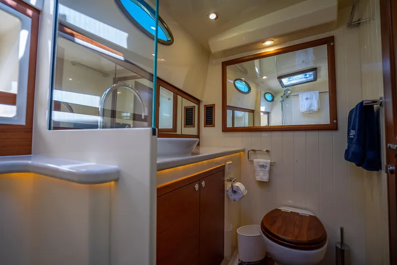 Miller Time Yacht Photos Pics Luxurious bathroom in 2017 Palm Beach Motor Yachts PB45, featuring elegant wood accents and modern fixtures.