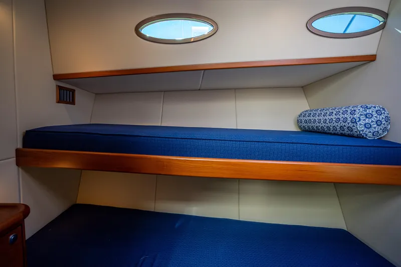 Miller Time Yacht Photos Pics 2017 Palm Beach Motor Yachts PB45 cabin with blue bedding and porthole windows.