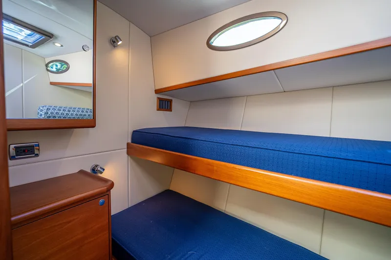 Miller Time Yacht Photos Pics 2017 Palm Beach Motor Yachts PB45 cabin with blue bunk beds and wooden accents.