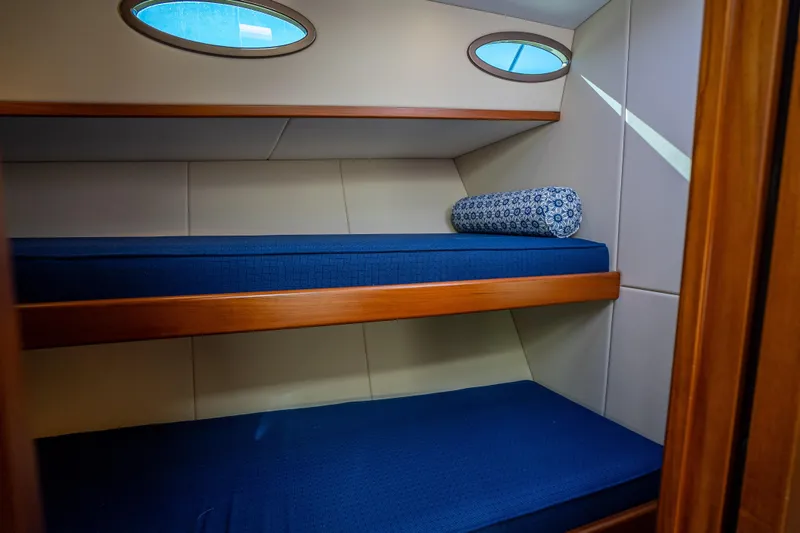 Miller Time Yacht Photos Pics 2017 Palm Beach Motor Yachts PB45 cabin with blue bunk beds and porthole windows.