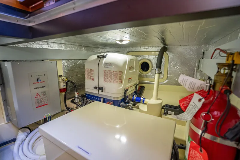 Miller Time Yacht Photos Pics Engine room of 2017 Palm Beach Motor Yachts PB45 with generator and fire extinguisher.