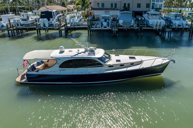 Miller Time Yacht Photos Pics 2017 Palm Beach Motor Yachts PB45 cruising in a marina, elegant design and sleek profile.