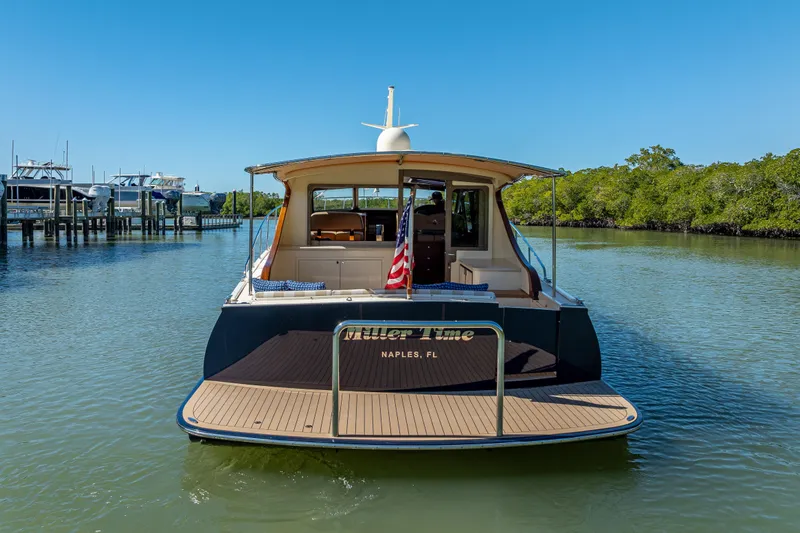 Miller Time Yacht Photos Pics 2017 Palm Beach Motor Yachts PB45 on calm water, rear view, sunny day.