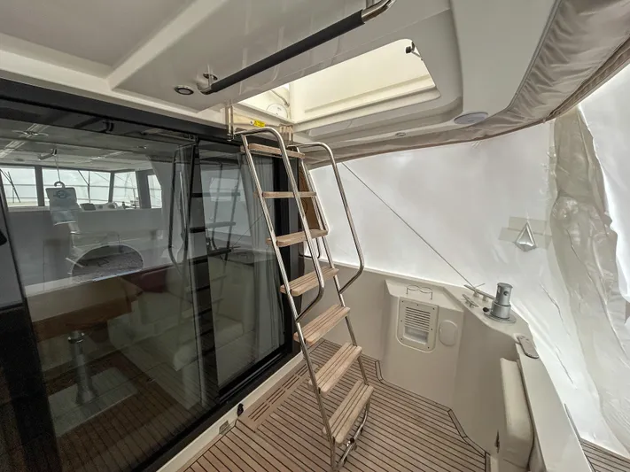  Yacht Photos Pics Interior view of 2023 Beneteau Swift Trawler 35 with ladder and seating area.