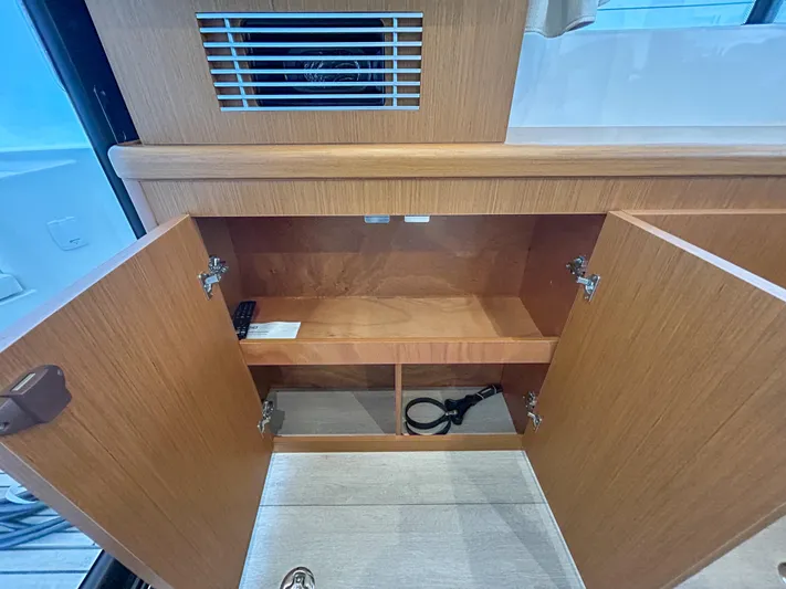  Yacht Photos Pics 2023 Beneteau Swift Trawler 35 interior cabinet with open wooden doors.