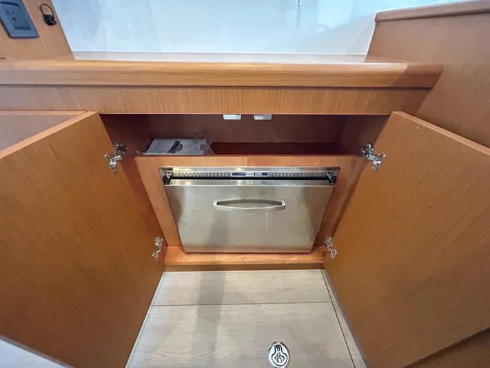  Yacht Photos Pics 2023 Beneteau Swift Trawler 35 interior with wooden cabinetry and built-in stainless steel appliance.