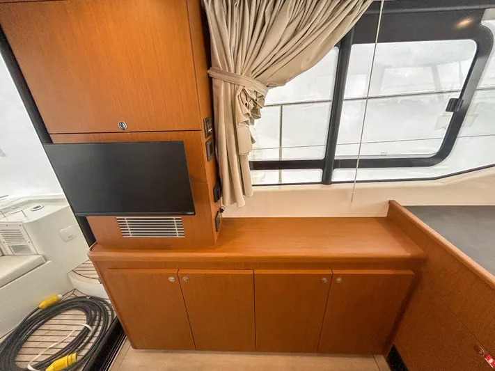  Yacht Photos Pics 2023 Beneteau Swift Trawler 35 interior with wood cabinetry and window view.