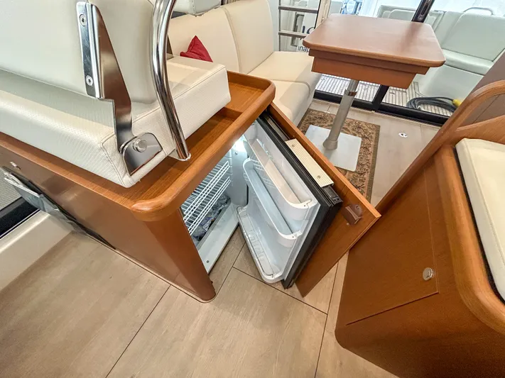  Yacht Photos Pics 2023 Beneteau Swift Trawler 35 interior with open fridge and seating area.