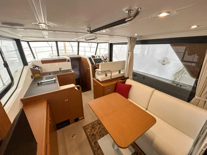  Yacht Photos Pics 2023 Beneteau Swift Trawler 35 interior with modern kitchen and cozy seating area.