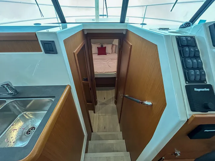  Yacht Photos Pics Interior view of 2023 Beneteau Swift Trawler 35, featuring stairs and cozy cabin.