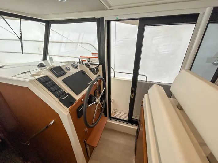  Yacht Photos Pics 2023 Beneteau Swift Trawler 35 helm station with modern controls and panoramic windows.