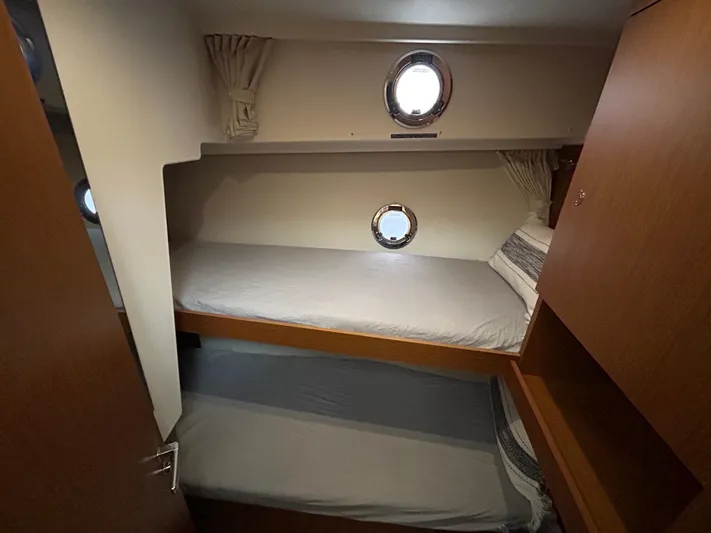  Yacht Photos Pics 2023 Beneteau Swift Trawler 35 cabin with bunk beds and portholes.