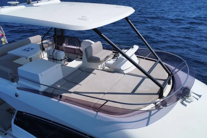  Yacht Photos Pics Luxurious 2021 Prestige 460 yacht flybridge with seating, table, and ocean view.