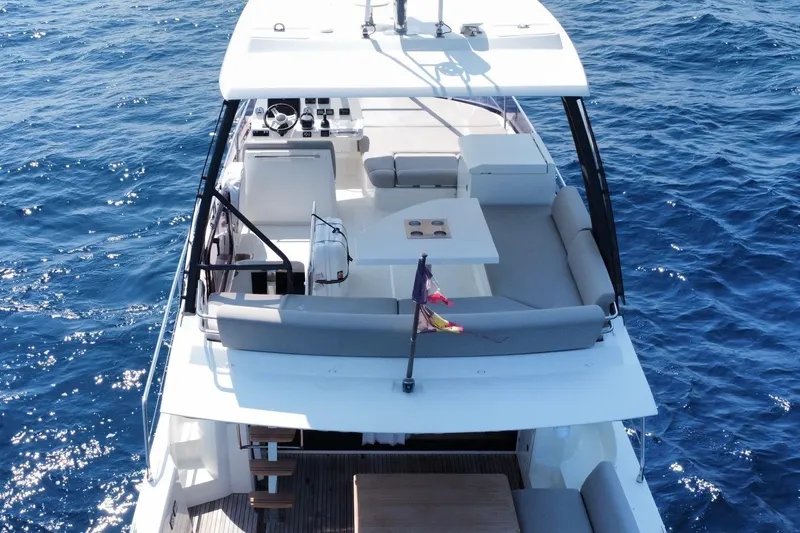  Yacht Photos Pics Prestige 460 yacht, 2021 model, cruising on blue ocean waters, top deck view.