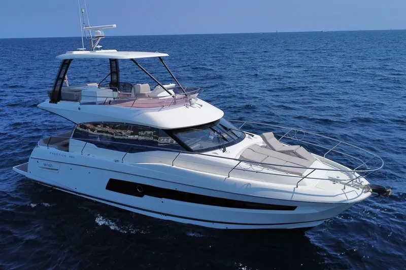  Yacht Photos Pics 2021 Prestige 460 yacht cruising on open sea under clear blue sky.