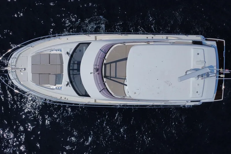  Yacht Photos Pics Aerial view of 2021 Prestige 460 yacht on dark water.