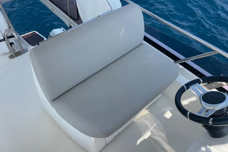  Yacht Photos Pics Luxury seating and steering area on 2021 Prestige 460 yacht, overlooking blue ocean waters.